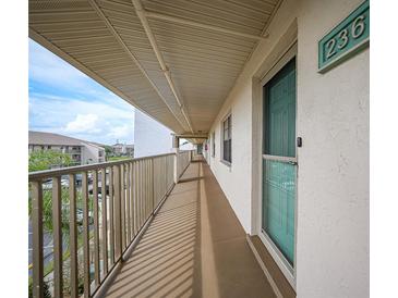 Building hallway with teal door and balcony at 175 Kings Hwy # 236, Punta Gorda, FL 33983