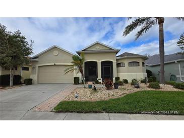 Attractive single-story home with a two-car garage and well-manicured landscaping at 24412 Lakeview Pl, Punta Gorda, FL 33980