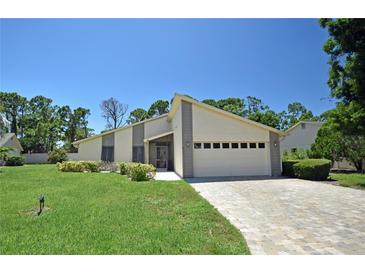 Single-story home with a paved driveway and well-manicured lawn at 412 Cypress Forest Dr, Englewood, FL 34223