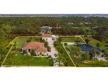 Beautiful aerial view of the property showcasing its mature landscaping and desirable location at 5208 Churchill Rd, Port Charlotte, FL 33981