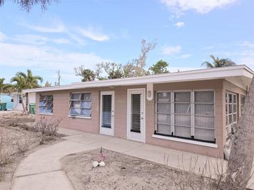 Ranch-style home with a flat roof and light brown exterior at 1205 Gulf Blvd, Englewood, FL 34223