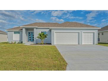 Newly built home with two-car garage and well-manicured lawn at 14304 Amestoy Ave, Port Charlotte, FL 33981