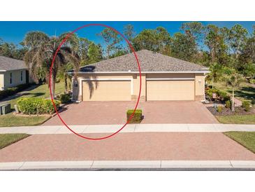 Charming single-story home with a two-car garage, paver driveway, and well-maintained landscaping at 13488 Abercrombie Dr, Englewood, FL 34223
