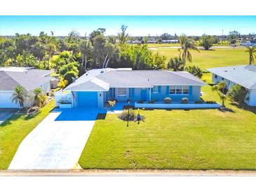 Single-story home with driveway and spacious backyard, situated in a residential neighborhood at 16 Golfview Ct, Rotonda West, FL 33947