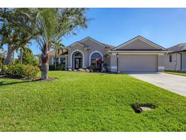 One-story home with attractive landscaping and a two-car garage at 76 Long Meadow Ct, Rotonda West, FL 33947