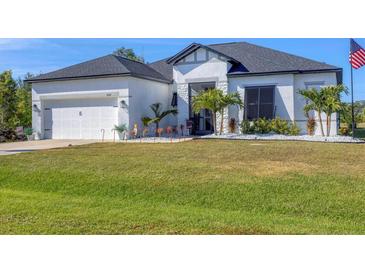 Charming single-Gathering home with well-maintained lawn, garden, and a two car garage at 9157 Genesee St, Port Charlotte, FL 33981