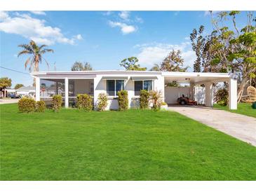 White single story home with carport and fenced yard at 1305 Rocky Creek Ln, Englewood, FL 34224