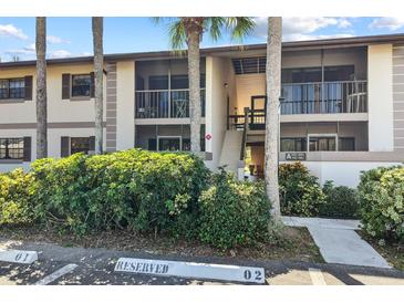 Building exterior with palm trees and parking spaces at 1515 Forrest Nelson Blvd # A 202, Port Charlotte, FL 33952