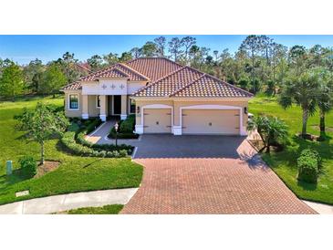 Beautiful one-story home with tile roof, two-car garage, and landscaped yard at 26852 Faldo Ln, Englewood, FL 34223