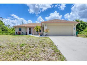 Charming single-story home featuring a two-car garage and well-maintained front yard at 4036 Elvington Rd, Port Charlotte, FL 33981