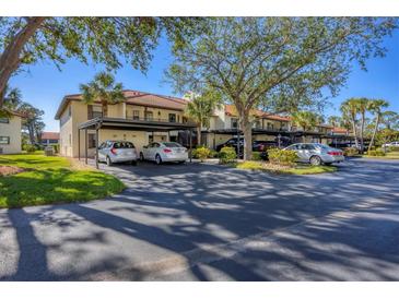 Condo complex with carport parking and lush landscaping at 520 Pine Hollow Cir # 520, Englewood, FL 34223