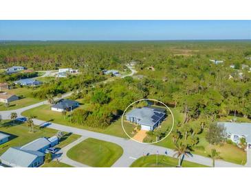 Aerial view of a single-Gathering home with a large backyard and canal at 6096 Bowie Ln, Englewood, FL 34224