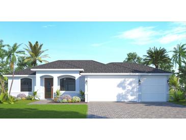 One-story home with light blue exterior, two-car garage, and landscaping at 7320 Freeberg Cir, Port Charlotte, FL 33981