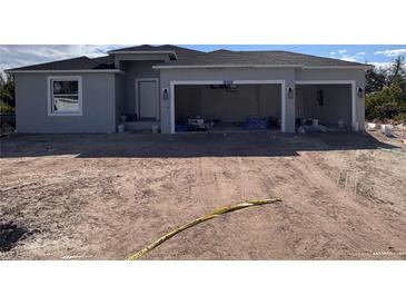 Newly constructed home with a two-car garage and spacious driveway at 12455 Deepwoods Ave, Port Charlotte, FL 33981