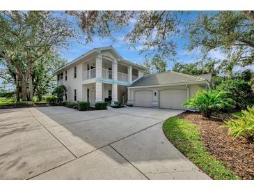 Two-story house with attached garage and landscaping at 14049 Willow Glen Ct # 242, Port Charlotte, FL 33953