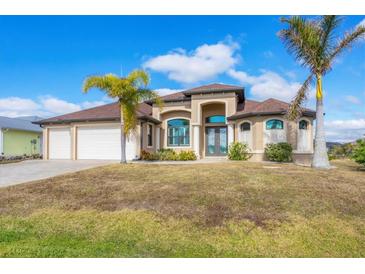 Beautiful 2-story home with a 3-car garage and landscaped yard at 15442 Meacham Cir, Port Charlotte, FL 33981