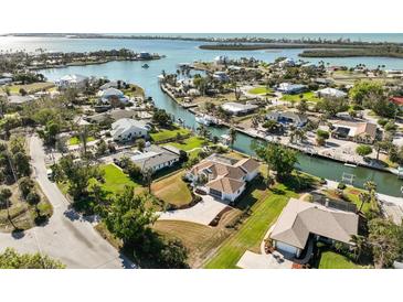 Stunning aerial view of waterfront home with a private dock and lush foliage at 385 Pelican Bnd, Placida, FL 33946