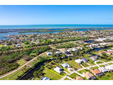 Aerial view of waterfront property with private dock and lush landscaping at 4678 Arlington Dr, Placida, FL 33946