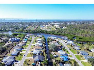An aerial view showcasing a home nestled within a waterfront community at 560 Sandlor Dr, Englewood, FL 34223