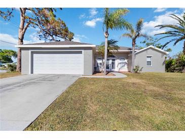 Front view of a house with a garage and palm trees at 792 Lehigh Rd, Venice, FL 34293