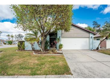 One-story home with attached garage and landscaped yard at 691 Linden Dr, Englewood, FL 34223