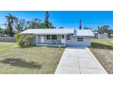 Charming single story home with a metal roof and spacious yard at 780 Orchard Ln, Englewood, FL 34223