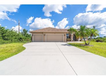 Charming single-story home featuring a three-car garage, mature palms, and a well-manicured lawn at 116 Hercules Dr, Rotonda West, FL 33947