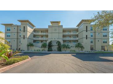Beautiful condominium building featuring manicured landscaping and a stylish architectural design at 10045 Links Ln # 203, Rotonda West, FL 33947