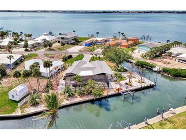 Waterfront home with a screened lanai, seawall, dock and mature tropical landscaping at 232 Bahia Vista Dr, Englewood, FL 34223