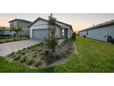 Charming single-story home featuring a two-car garage and well-maintained front yard with landscaping at 6237 Fish Eagle Ct, Nokomis, FL 34275