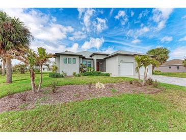 Charming single Gathering home featuring a lush green lawn and complemented by swaying palm trees at 237 W Pine Valley Ln, Rotonda West, FL 33947