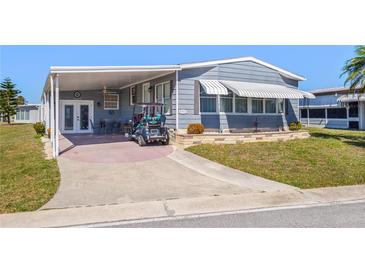 Charming single-story home with a covered carport and well-maintained landscaping at 5703 Holiday Park Blvd, North Port, FL 34287