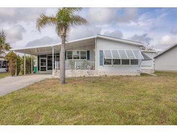 Charming single-story home with a covered carport and a cozy front porch at 8436 Buttonquail Dr, Englewood, FL 34224