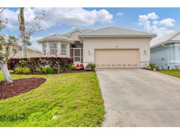 Charming single-Gathering home featuring a two-car garage, well-maintained lawn, and attractive landscaping at 16 Windward Ter, Placida, FL 33946