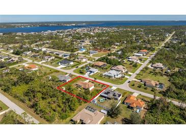 Aerial view showcasing the property's location within a beautiful, established neighborhood near the water at 5441 Farley St, Port Charlotte, FL 33981