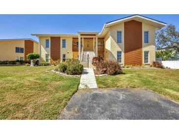 Inviting two-story condo building with well-manicured lawn, walkway, and charming curb appeal at 6699 San Casa Dr # Q3, Englewood, FL 34224