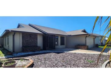 Charming single-story home features a well-maintained lawn and attached garage at 95 Mark Twain Ln, Rotonda West, FL 33947