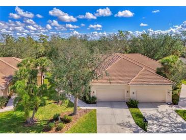 Beautiful single-Gathering home with a well-manicured lawn, mature trees, and a two-car garage at 14298 Reserve Ct, Port Charlotte, FL 33953