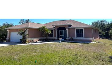 Charming single-story home featuring a well-manicured lawn and a screened front entry at 14399 Morristown Ave, Port Charlotte, FL 33981