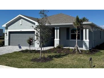 Charming single-Gathering home features a gray exterior and a well-maintained front yard at 8644 Saint Kitts Cir, Englewood, FL 34224