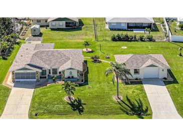 Well-maintained homes featuring lush lawns and mature landscaping in a desirable community at 9423 El Campo Ave, Englewood, FL 34224