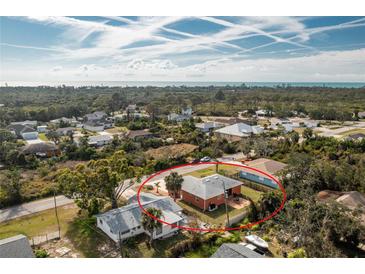 Lovely coastal home with an expansive yard, partially fenced-in, and lush greenery surrounding the property at 1080 Panda Rd, Venice, FL 34293