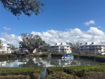 Waterfront condos offer picturesque views, a private dock and access to boating on a sunny, cloud-filled day at 11000 Placida Rd # 702, Placida, FL 33946