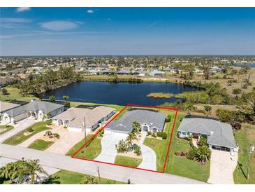 An aerial view of a home with mature landscaping overlooking a pond at 12 Sportsman Ter, Rotonda West, FL 33947