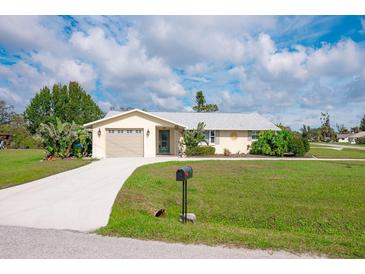 Charming single-story home with a well-manicured lawn, mature landscaping, and a two-car garage, enhancing its curb appeal at 2545 Geneva Rd, Venice, FL 34293
