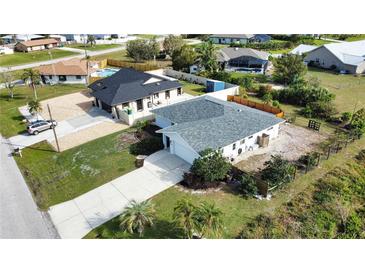 A charming single-Gathering home with a spacious driveway and well-maintained landscaping at 9265 Carnation Ave, Englewood, FL 34224