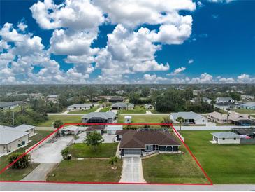 Sprawling single-Gathering home with large yard, multiple buildings, and ample parking at 10075 Bay Ave, Englewood, FL 34224