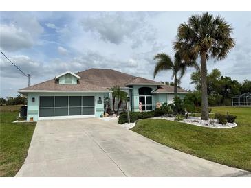 Charming single-Gathering home showcasing a well-manicured lawn, mature trees, and an attached two-car garage at 108 Fairway Rd, Rotonda West, FL 33947