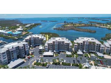 Beautiful aerial view of condos offering waterfront views, parking, and nearby amenities at 13313 Gasparilla Rd # C501 & Slip 11, Placida, FL 33946