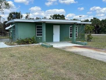 Inviting single-story home with a well-maintained lawn and a quaint, covered entrance at 1417 Terry Ave, Punta Gorda, FL 33980
